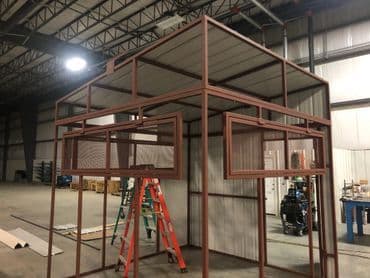 Steel structure with open windows in a spacious industrial workshop.