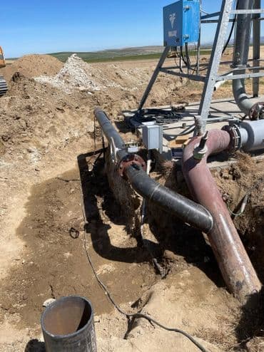 Pipes and equipment at a construction site for water management system installation.