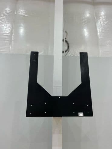 Basketball hoop backboard mounting bracket on a gym wall. Ideal for sports facility setup.